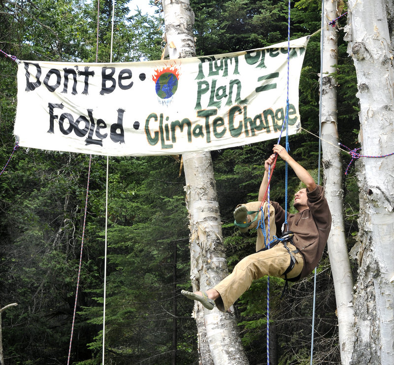 Kit Pearson from Fort Collins, Colo., practices tree climbing as Earth First! holds its North Woods Round River Rendezvous on private land in Coplin Plantation.