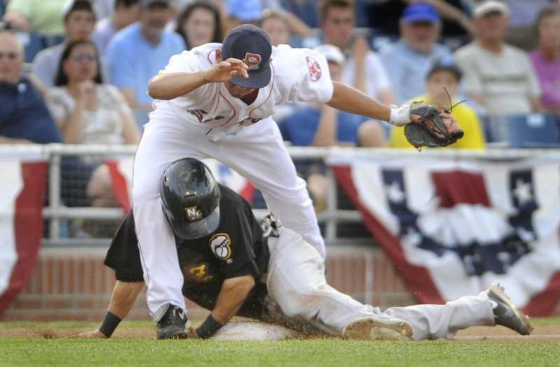 Sea Dogs third baseman Ray Chang gets tangled up with Darin Mastroianni of the Fisher Cats, who was safe during the third inning of Portland's 11-4 win Wednesday night.