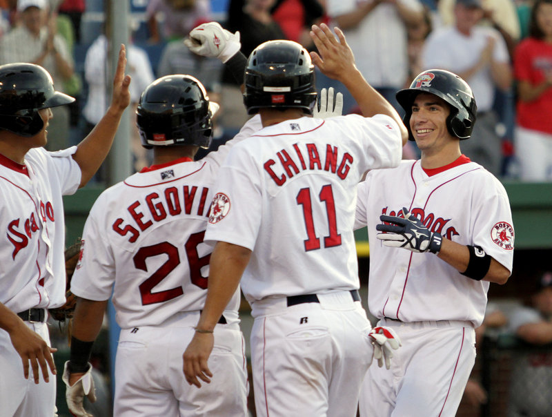 Nate Spears strikes a big blow Friday night for the Portland Sea Dogs and is all smiles as he’s welcomed by teammates at home plate after hitting a grand slam in the second inning that gave Portland the lead for good in a 7-5 victory over the New Britain Rock Cats.