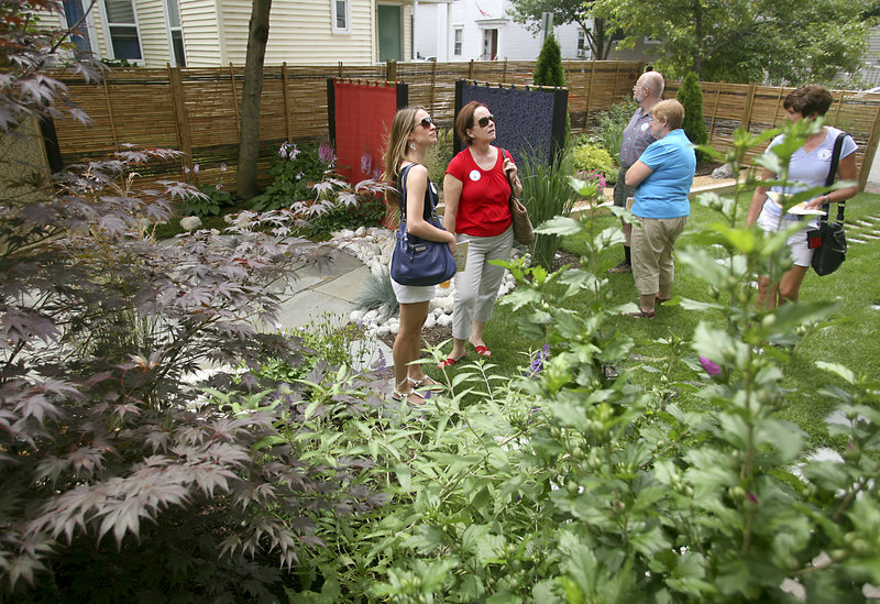 Visitors view the Japanese garden at 59 Lafayette St. The garden was created to provide a peaceful yet energizing landscape..