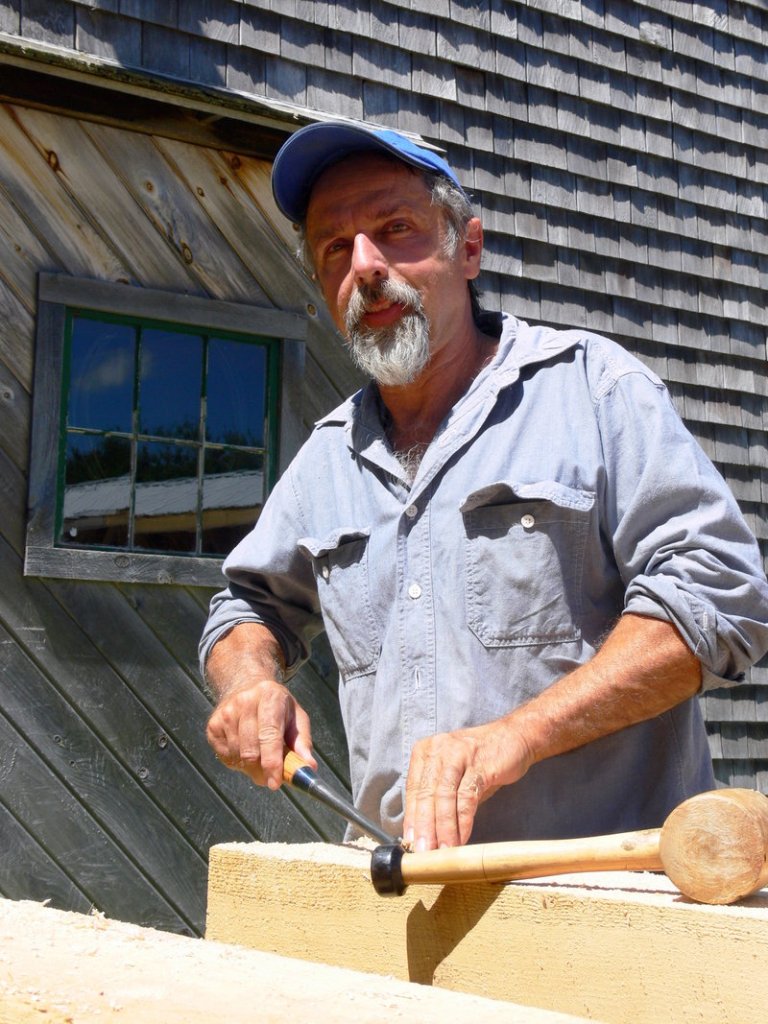 Andy Buck, a timber framer and friend of Bob Dunning, works on the memorial bridge to Pondicherry Park.