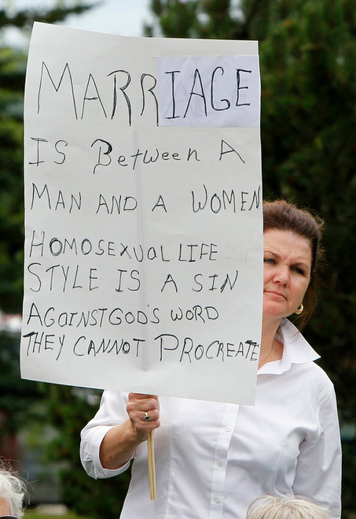 A supporter helps the National Organization for Marriage kick off its “One Man, One Woman” bus tour. Members plan to visit 17 states where gay marriage is still an issue.