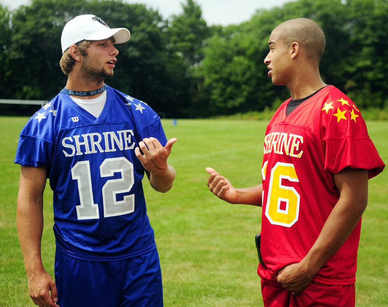 Windham's Jackson Taylor, left, talks with Brunswick's Rashon Edgerton on Tuesday during Lobster Bowl Media Day at Hebron Academy. Both will play at UMaine this fall.