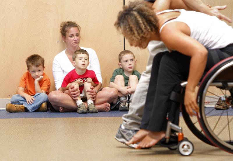 Tommy Churchill, Sam Jacques and Caleb Wandell, left to right, with Rebecca Williams, watch an Axis Dance Company performance at the Morrison Developmental Center in Scarborough on Tuesday. The boys attend a preschool program there.