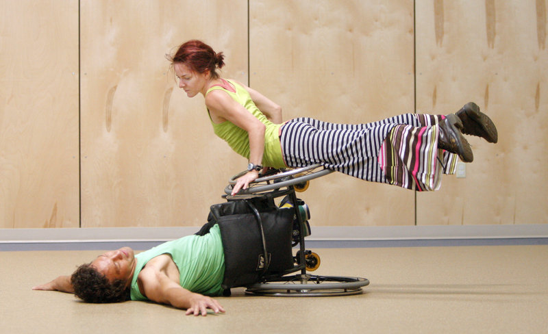 Rodney Bell, bottom, and Sonsheree Giles of Axis Dance Company perform at the Morrison Developmental Center.