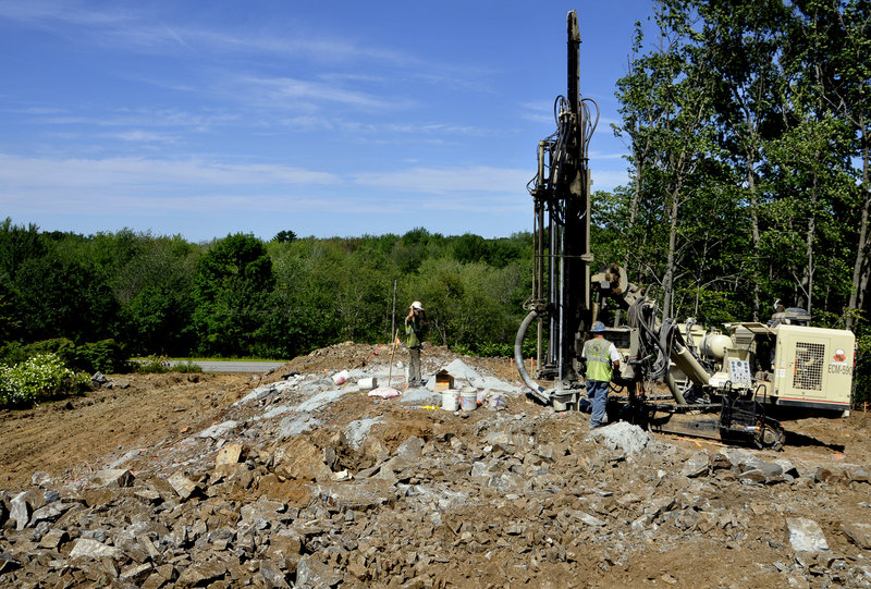 Workers prepare to blast for a road at the Eastman Meadows site, Cape Elizabeth’s first new condominium development in 20 years.