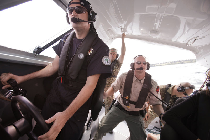 Zoran Lasica, of the marine police in Montenegro, pilots a Maine Marine Patrol boat during training in Casco Bay on Wednesday. Tom Hale, center, and other Maine Marine Patrol officers are training the Montenegrin navy and marine police this week.