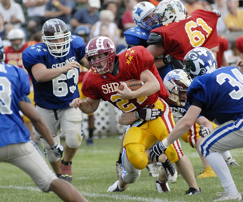 Lonnie Hackett of Bangor, whose 160 yards rushing included the touchdown that clinched it for the East, looks for an opening Saturday against the West defense in the Lobster Bowl at Biddeford. The East rallied to win for the fourth time in the last five seasons, 40-35.