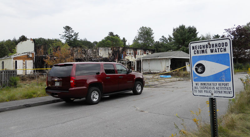 The apartment building (in background) at Brunswick Naval Air Station annex in Topsham that was destroyed in a fire earlier this month.