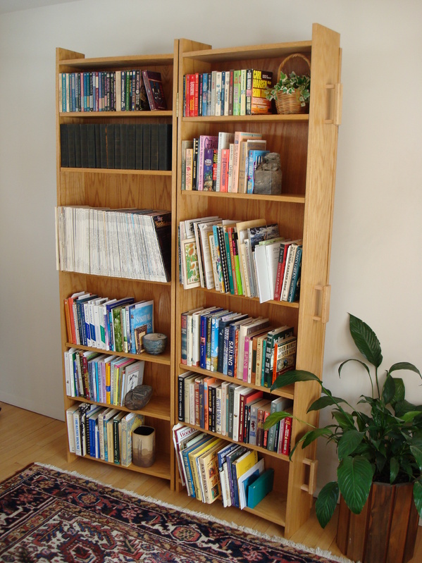 The bookcase coffin, basically two boxes hinged together, has adjustable shelves.