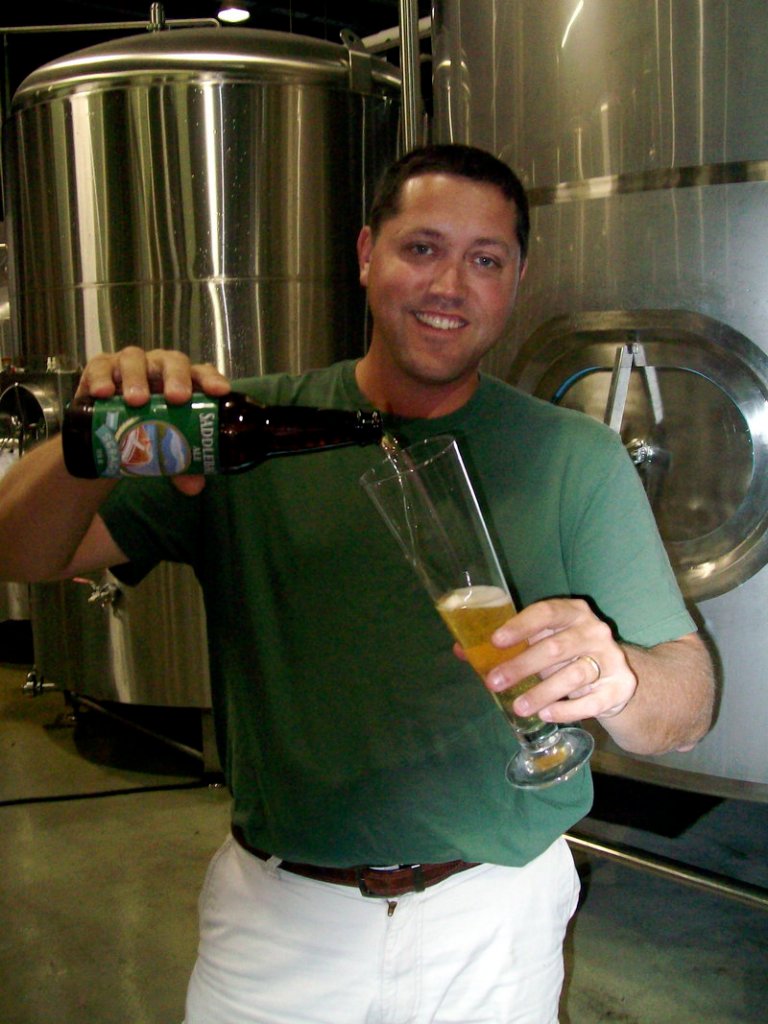 Kai Adams, owner and CEO of Sebago Brewing Co., pours a Saddleback Ale, a brew that will be introduced at this weekend's Saddleback Bluegrass Festival in Rangeley.