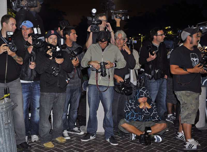 Members of the media wait for actress Lindsay Lohan at the Century Regional Detention Facility in Lynwood, Calif., early Monday. She was discharged at 1:35 a.m. Monday after serving 14 days of a 90-day term in a 2007 drug case.