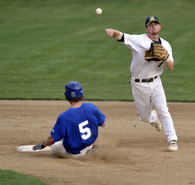 North Shore runner Tyler Kuehl, left, slides into second too late as Sanford’s Brett Mollenhauer fires the ball to first for a double play Tuesday night at Goodall Park. The Mainers won 5-1 to tie their three-game NECBL playoff series.