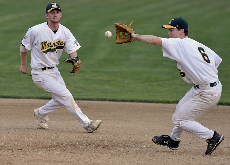 With shortstop Brett Mollenhauer looking on, Joe Wendle snags an infield grounder, tags second and throws to first for a double play against North Shore in Game 2 of their New England Collegiate Baseball League playoff series at Goodall Park in Sanford.