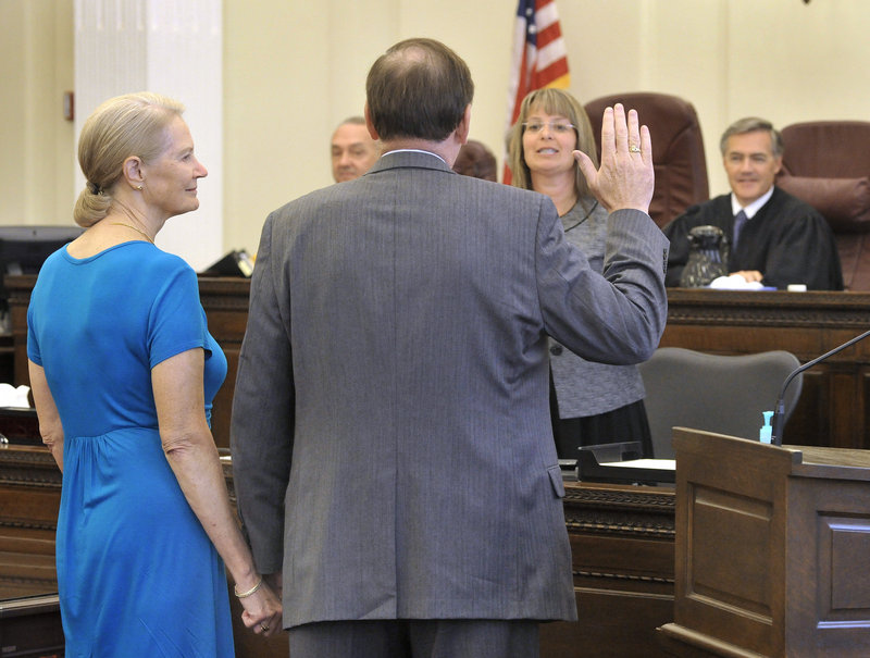 Thomas Delahanty II, with his wife, Ruth, at his side, is formally sworn in as the new U.S. attorney for Maine at U.S. District Court in Portland on Friday. “I greatly appreciate the honor of President Obama’s nomination,” Delahanty told the crowd of legal dignitaries and family members.
