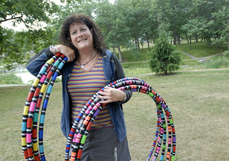 Tingley hoists some of her hoops. These are not the flimsy plastic playthings of childhood – Tingley’s hoopes are crafted from PVC pipe and filled with a bit of water to help keep them aloft.