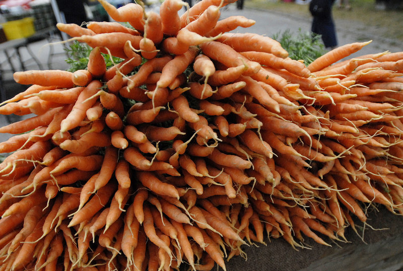 Carrots from South Paw Farm in Unity are arranged in a big, colorful display at the farmers market in Deering Oaks last weekend.