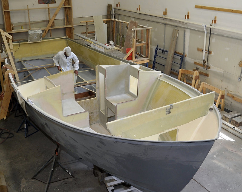 Steve Osborne, a technician at the Six Rivers Marine facility in North Yarmouth, takes measurements for installing gas tanks on a Blackhorse 29 being built at the boatyard, which was open to the public Tuesday as part of a two-day, first-of-its-kind event.