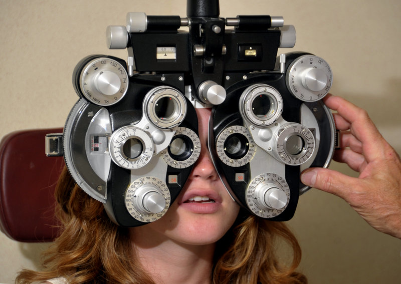 Addison Wood, 14, has her eyes examined by her optometrist, Dr. Steven Goldstein, at Casco Bay Eye Care.