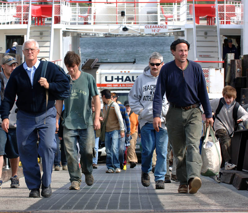 A crowd of people get off the Casco Bay Ferry, Machigonne, arriving in Portland from Peaks Island.