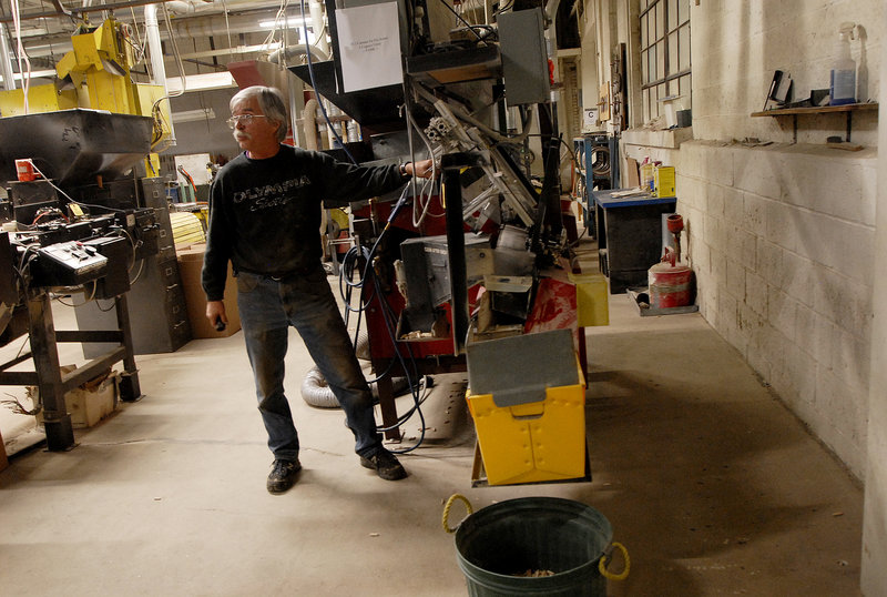 Longtime employee Foster Davis demonstrates an automatic sorter at the Saunders Brothers mill in Locke Mills on Monday. "I can get every machine running here in 10 minutes," he said.