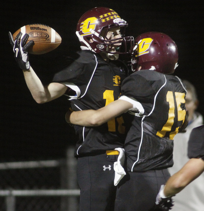 Derek Roberts of Cape Elizabeth, left, is welcomed by Austin Shields after scoring on a 92-yard kickoff return in the first quarter of the 24-21 victory against visiting Falmouth.