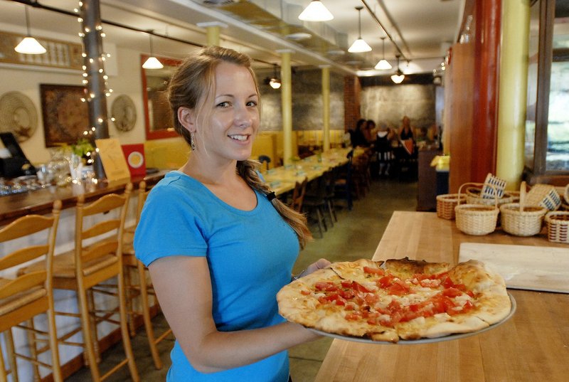 Holly Toothacker serves a pizza at Paolina's Way.