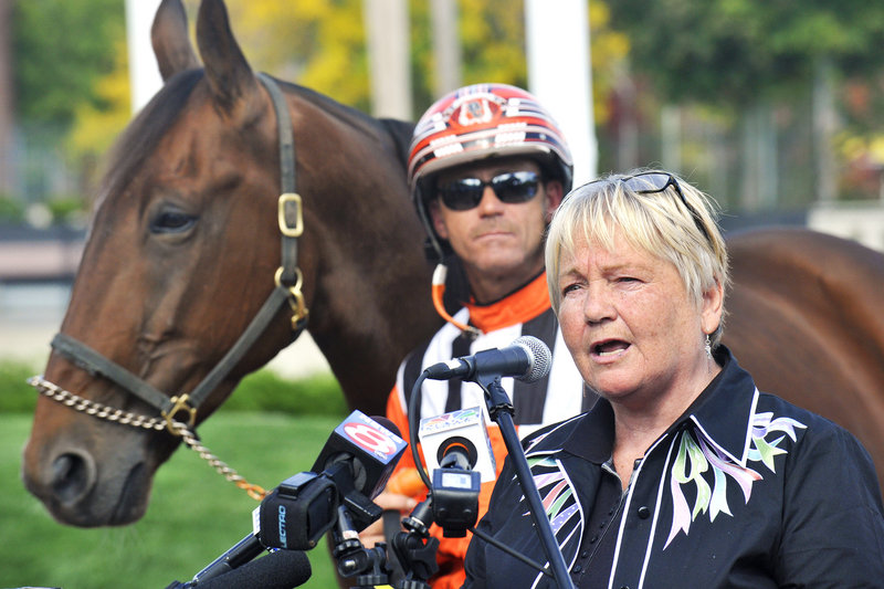 Biddeford Mayor Joanne Twomey speaks in favor of a racino complex Wednesday at Mechanics Park. At rear is harness racer Drew Campbell.