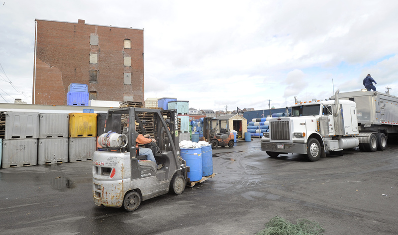 Fish are offloaded at the Portland Fish Pier last week. In the background is the Cumberland Cold Storage building, where Pierce Atwood plans to relocate its law offices. Such different uses in close proximity inevitably bring conflict, and the city must be willing to protect marine uses.