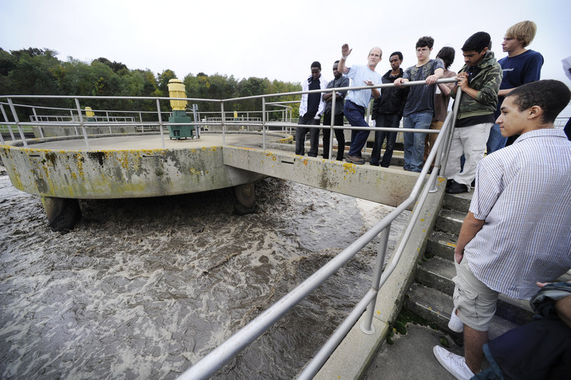 Portland Water District senior operator Jim Ward explains how an aeration tank works to Casco Bay High juniors at the city’s wastewater treatment facility Friday. Their goal was to learn the science concepts involved in preserving water as a resource.