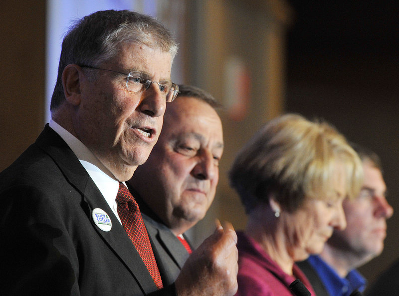 From left, Eliot Cutler makes a point as rival candidates for governor Paul LePage, Libby Mitchell and Shawn Moody stand by at Wednesday’s Portland Regional Chamber breakfast. Kevin Scott also attended the debate at the Holiday Inn by the Bay.