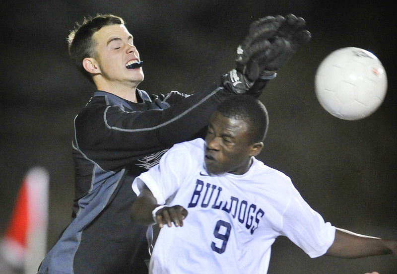 South Portland goalkeeper Shawn Shannon collides with Tony Yekah of Portland while knocking the ball away Thursday night during Portland’s 4-1 victory at Fitzpatrick Stadium. Portland improved to 11-1-1; South Portland is 9-3-1.