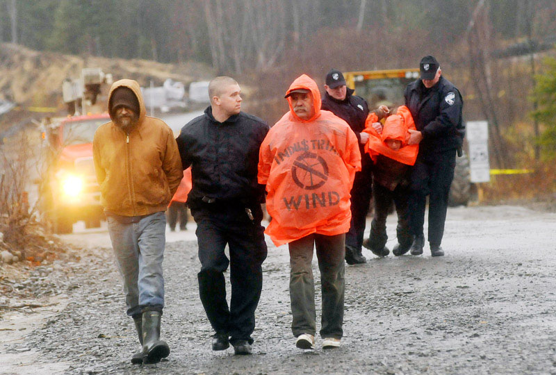 Protesters are arrested after blocking construction vehicles at the Rollins wind energy project in Lincoln today.