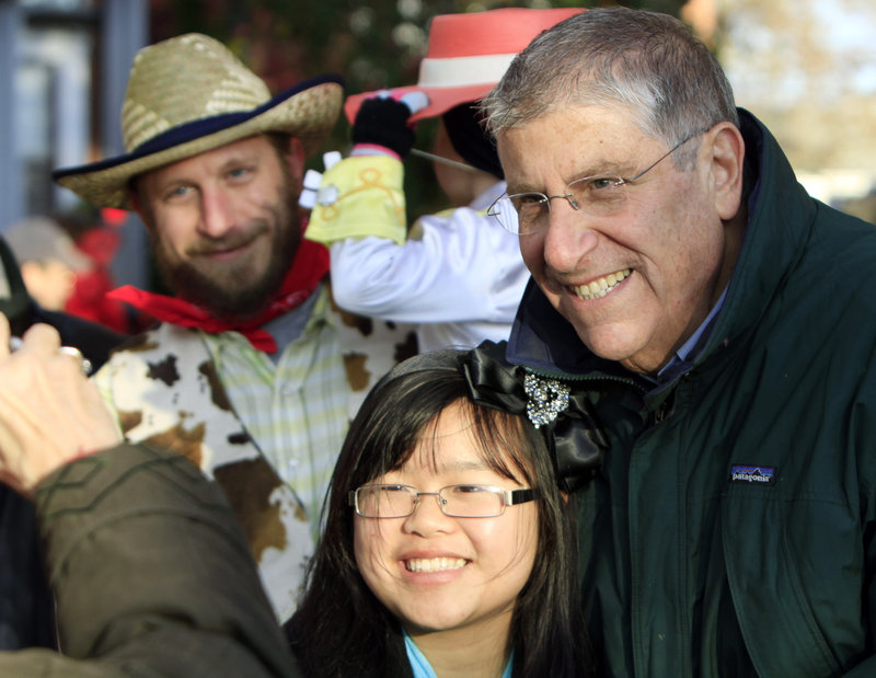 Eliot Cutler poses for photographs while campaigning at a Halloween parade in Brunswick on Sunday.