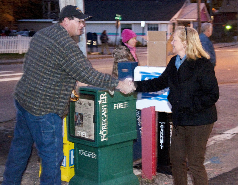 Rep. Chellie Pingree greets employees at Bath Iron Works as they arrive for work Monday. Opponent Dean Scontras did a bus tour of the 1st District.