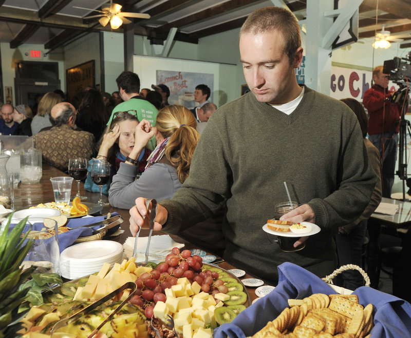 Nick Battista, a Pingree volunteer, visits the fruit platter at the Porthole restaurant in Portland. Tasty spreads were featured guests at all the campaign parties Tuesday night.