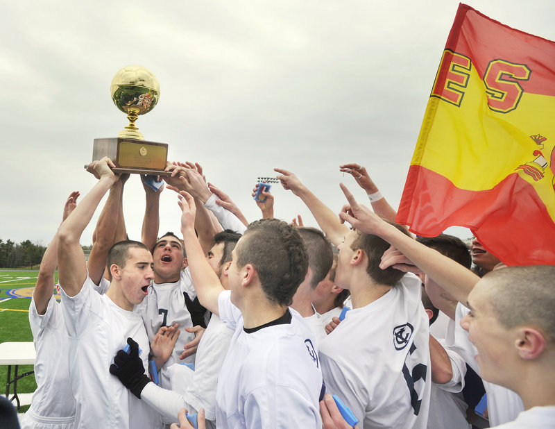 The Yarmouth boys celebrate their second state championship in three years Saturday after a 5-0 victory over Ellsworth in the Class B final at Falmouth High. Ellsworth Coach Brian Higgins marveled at the Clippers’ play, calling it an example of the difference in playing opportunities in the state’s two regions.