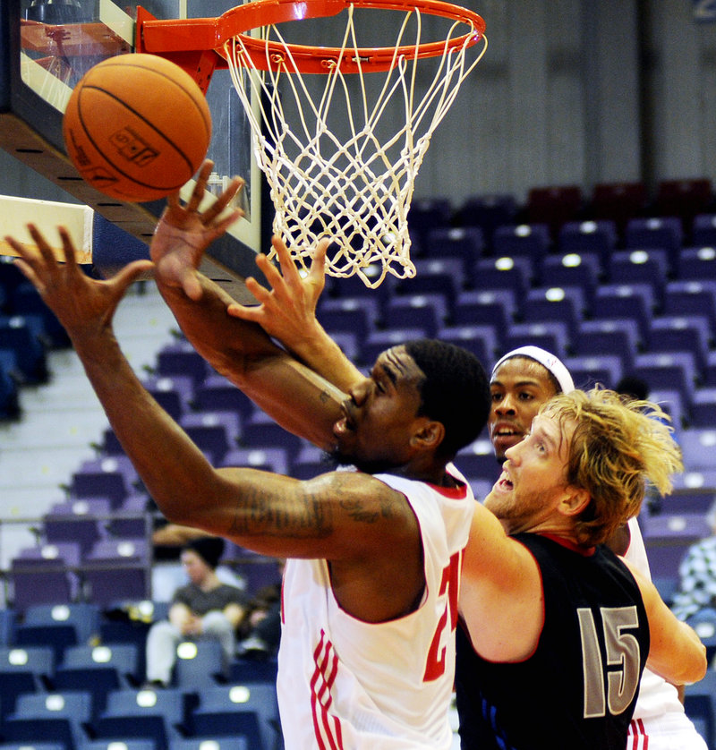 Maine's Paul Harris grabs at the ball in front of Springfield's Michael Williams during a preseason game Monday night in Augusta. Maine won 102-88.