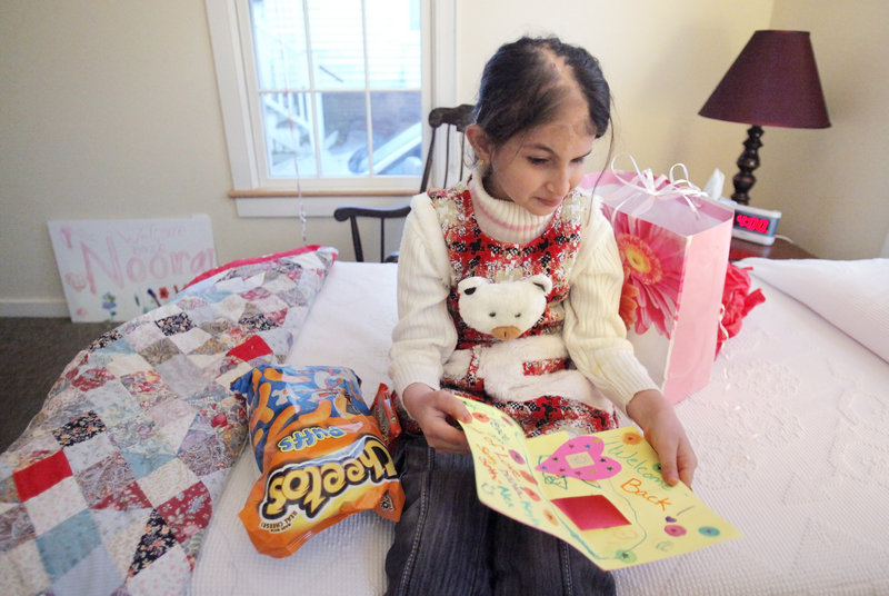 Noora Afif Abdulhameed looks at a card she opened after arriving in her room at the Ronald McDonald House on Wednesday. The Iraqi girl returned to Portland to have further reconstructive surgery on her scalp.