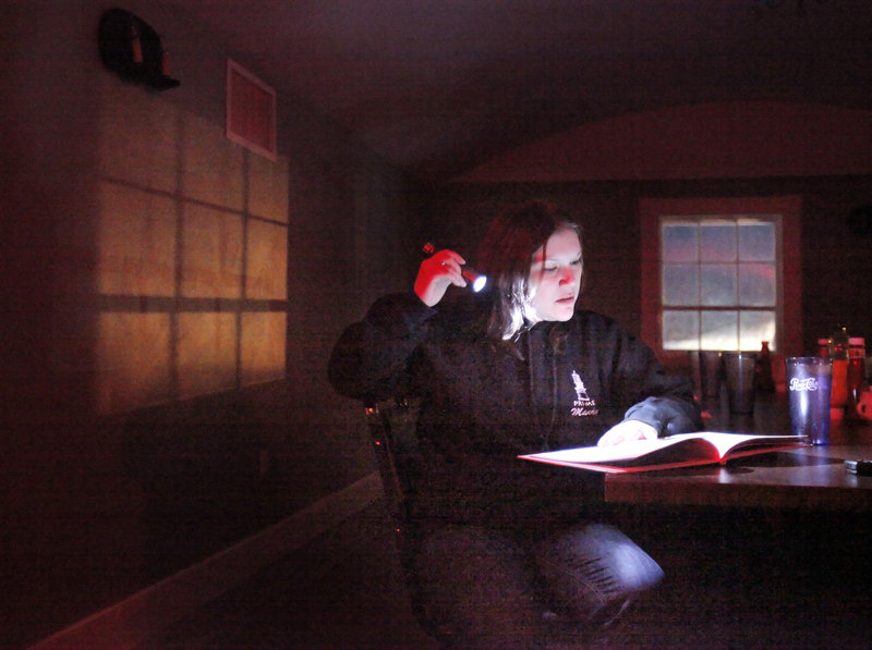 Mandy James reads “Twas the Night Before Christmas” in an attempt to get a response from a ghost, believed to be a young girl, at the Maine Street Grill. James runs Paranormal Researchers and Investigators of Maine with her husband, Louis Logsdon, and was looking into reports of unusual activity at the Standish restaurant.