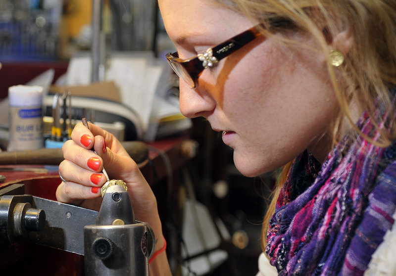 Nell Snyder, a bench jeweler, sets diamonds into an 18-karat gold diamond leaf-swirl band at Folia, a jewelry store on Exchange Steet in Portland. Gold is now about $1,360 per ounce, about twice the price it was in 2006.