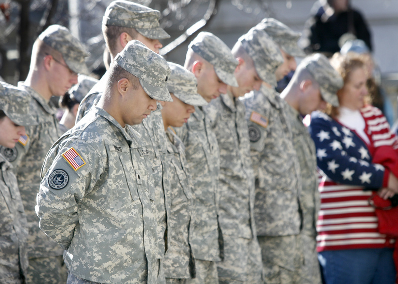 Members of the University of Maine's Army ROTC program bow their heads during the playing of taps after the laying of the wreath at Portland City Hall during the Veterans Day ceremony today.
