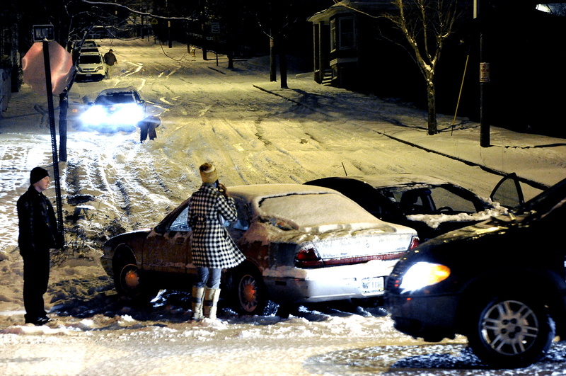 A Portland police officer, left, stands by one of two motorists who collided after sliding down Walnut Street to Washington Avenue on Monday. Other drivers, in background, used the curb to stop during Greater Portland’s first snowstorm of the winter, which created major traffic problems for evening commuters. Hundreds of vehicles slid off the slick roads. “It was a horror show,” said Portland police Lt. Gary Hutcheson.