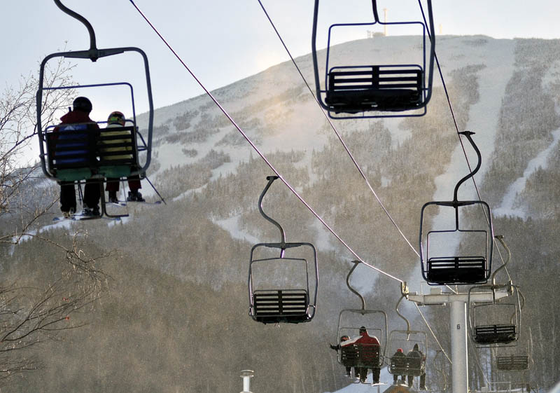 Skiers ride a chair-lift at Sugarloaf after a chair lift derailed in high winds earlier in the day. The derailment at Maine's tallest ski mountain Tuesday, sent skiers plummeting as far as 30 feet to the slope below and injuring several people.