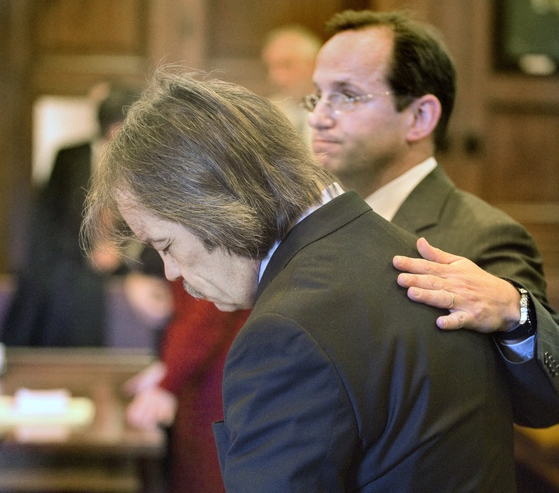 Defense attorney Robert Levine comforts William Hanaman on Wednesday in Cumberland County Superior Court.