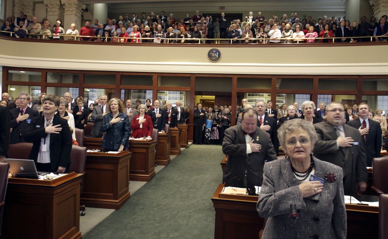 Members of the 125th Maine Legislature take the Pledge of Allegiance before being sworn into office Wednesday in the House chamber. For the first time in more than three decades, there are Republican majorities in both the House and Senate.