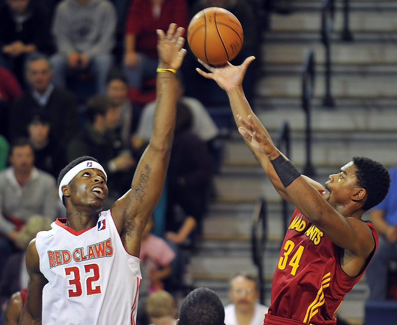 DeShawn Sims, left, of the Red Claws blocks a jump shot by Marvin Phillips of the Fort Wayne Mad Ants on Friday night at the Expo.