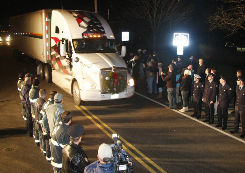 Members of the Portland police and fire departments line Ocean Avenue as the Wreaths Across America convoy arrives at Cheverus High School on Sunday.