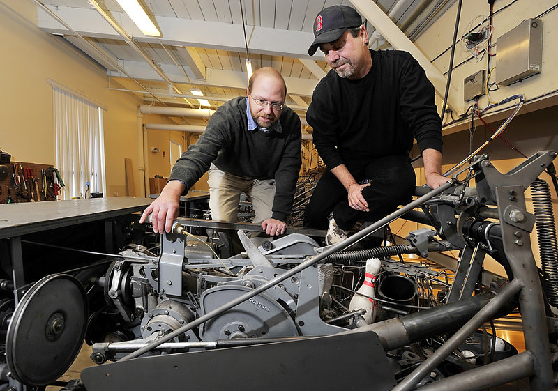 Reporter Ray Routhier oils a pin setter with Steve Closuit, operations manager and chief mechanic at Bayside Bowl, 58 Alder St. in Portland.