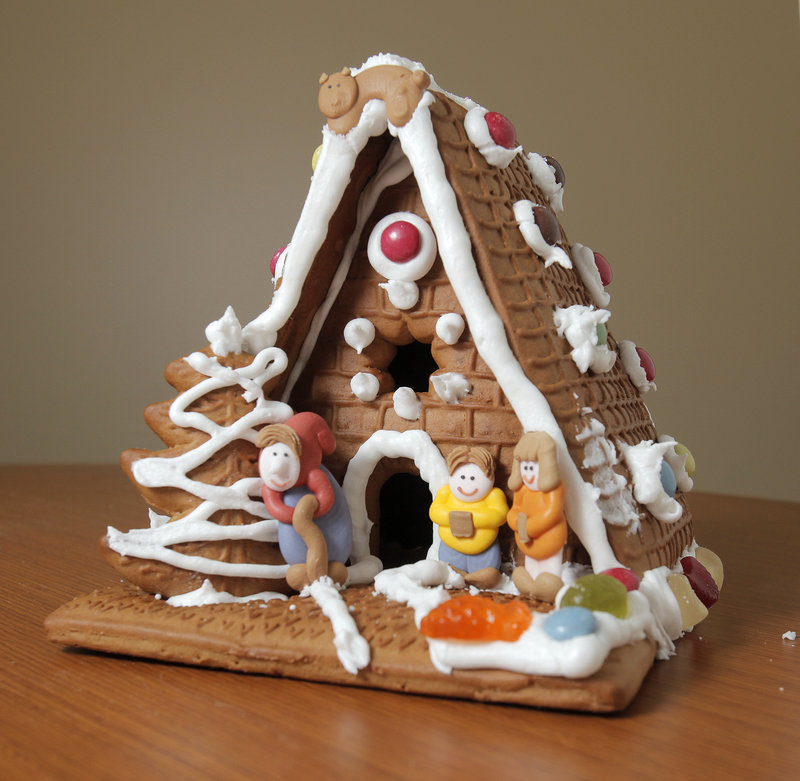 The German "Hexen House" from Trader Joe's stands out because of its A-frame design and the people out front.